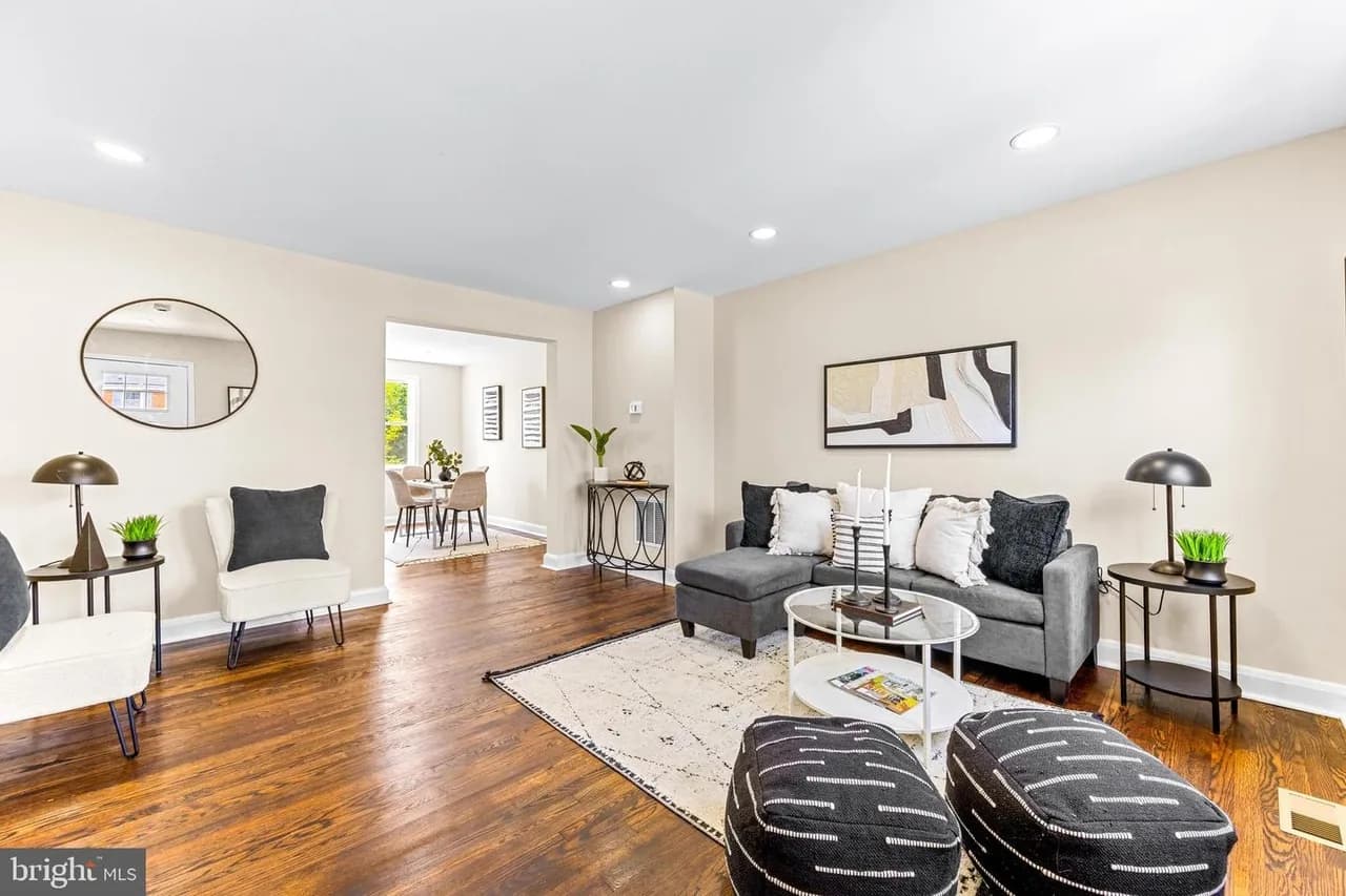 Joan Avenue living room with warm-toned flooring and a staircase