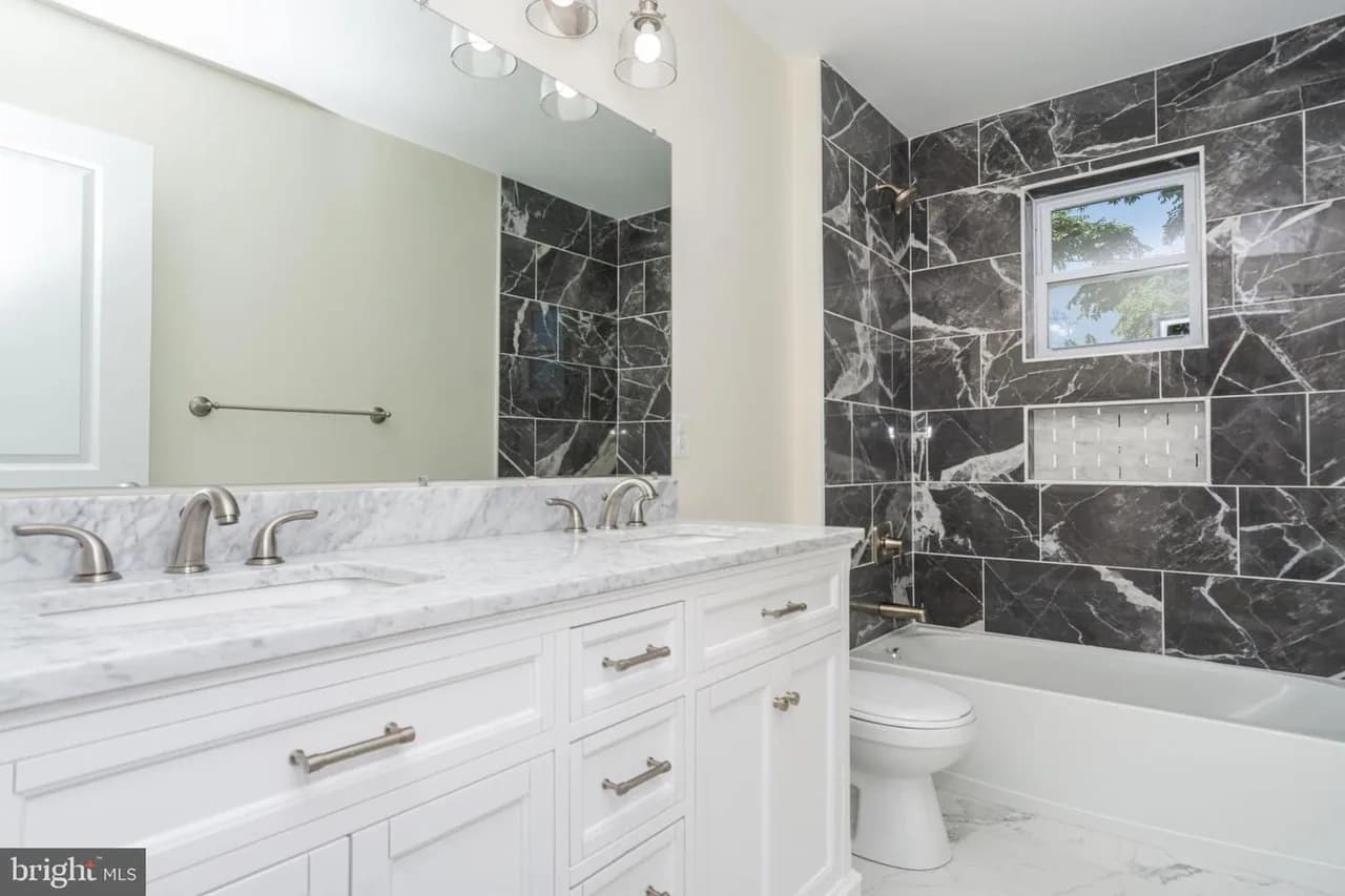 Baybriar bathroom with a wide vanity and dark shower surround