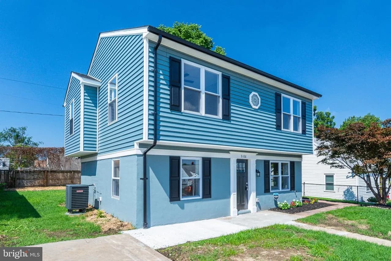 Blue two-story exterior of 3106 Baybriar Road with black shutters and white trim