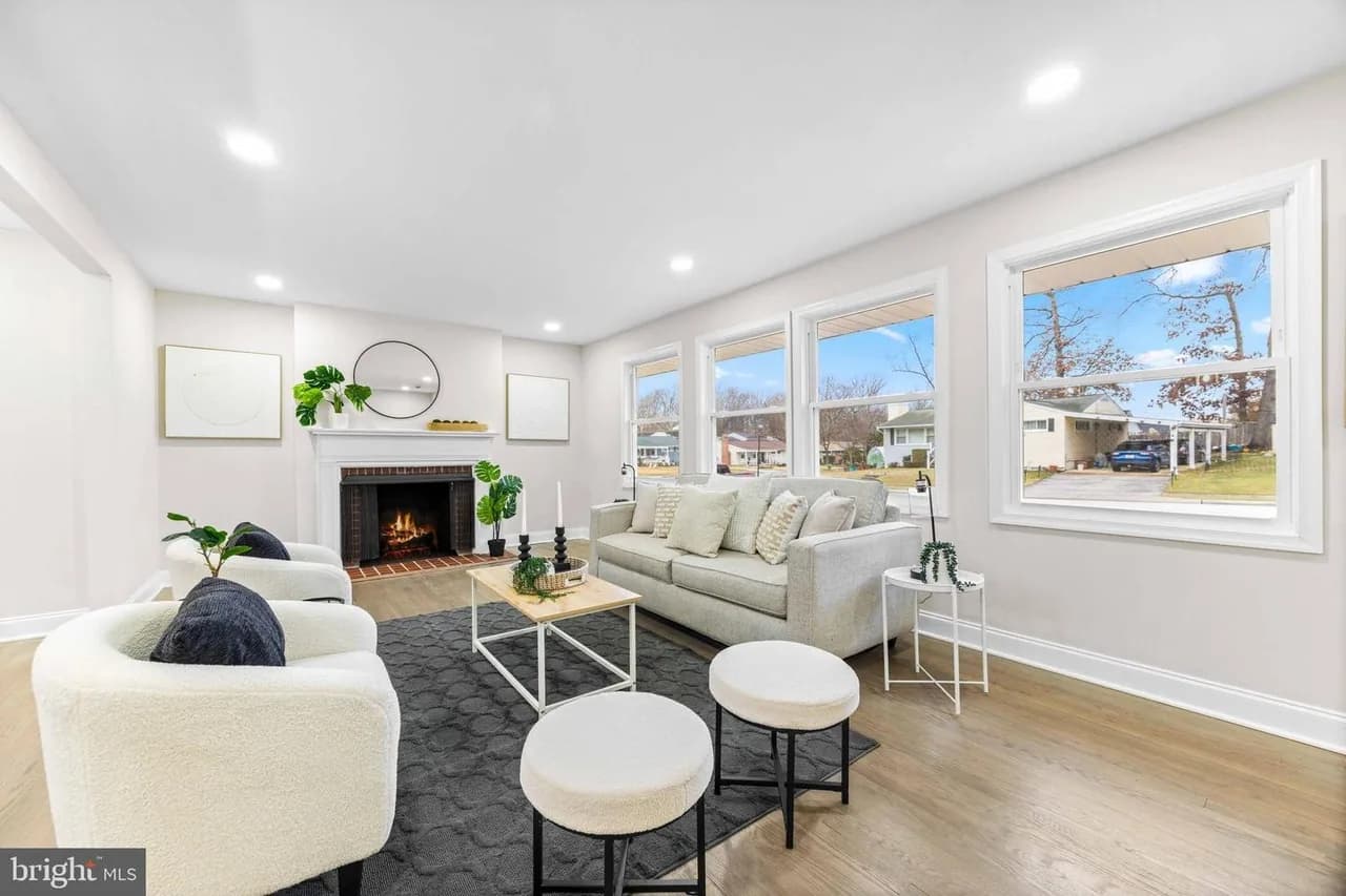 Bramleigh living room with a brick fireplace and broad windows