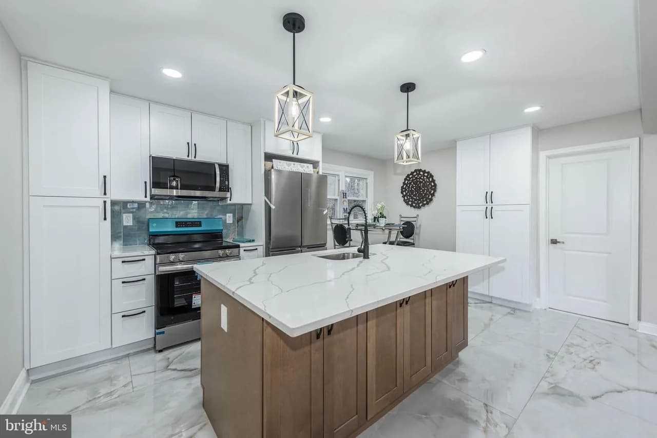 Beavers Court kitchen with white cabinets and a wood-tone island