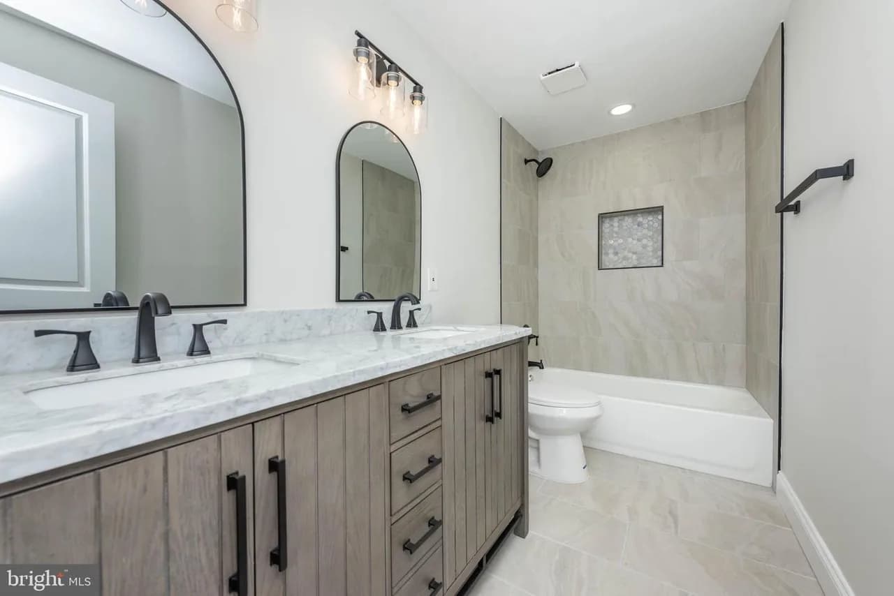 Walters Mill bathroom with a wood-tone vanity and paired mirrors